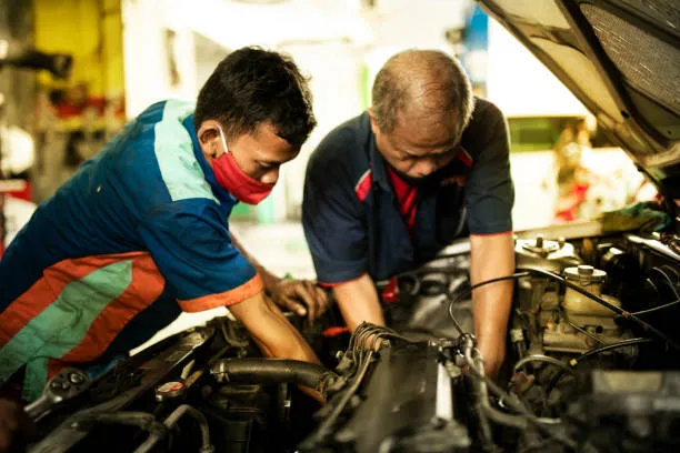 Teknisi profesional sedang melakukan overhaul mesin mobil
